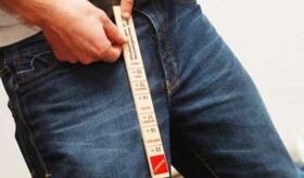 A man measures his penis with a ruler
