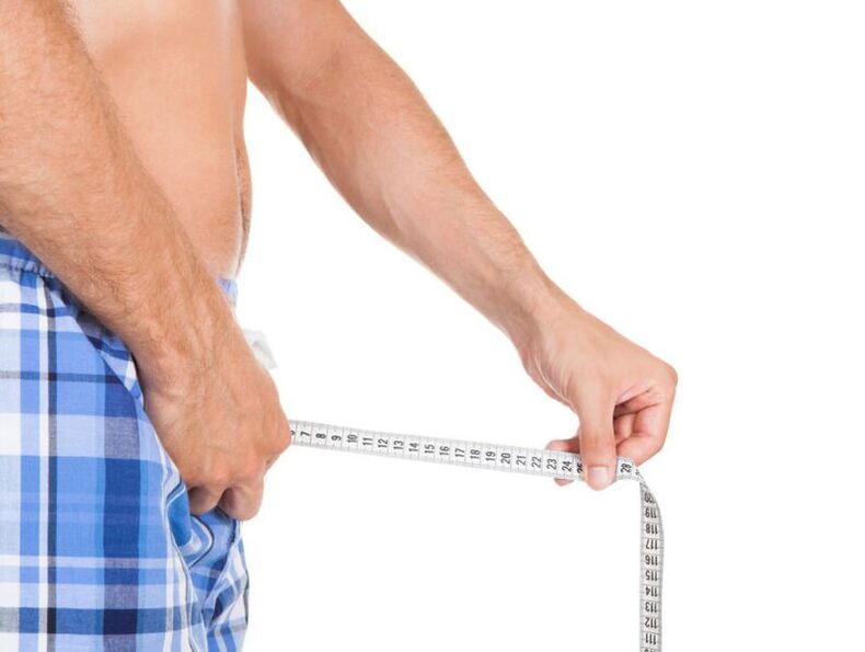 a man who measures his penis with a centimeter